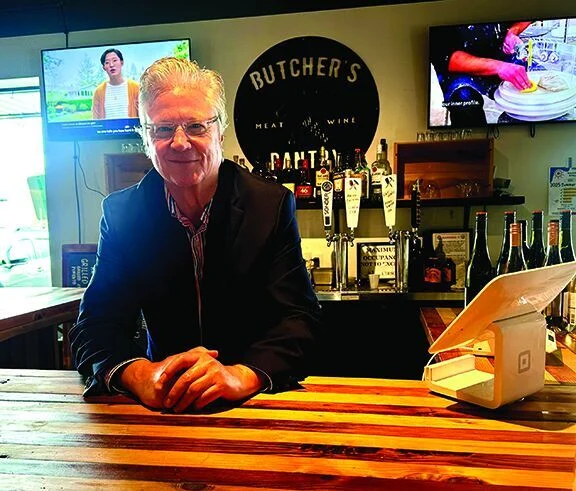 The owner of The Butcher&rsquo;s Pantry, behind the bar.